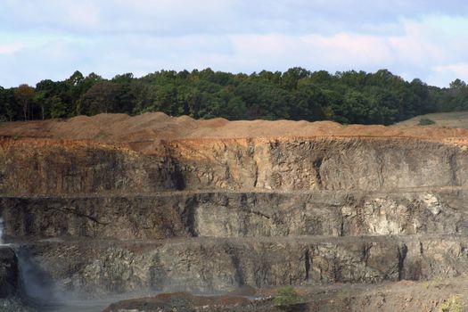 A Rock Quarry with trees and sky