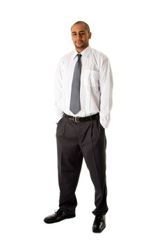 Handsome African Hispanic business man in white shirt, gray pants and tie, standing with hands in pocket, isolated