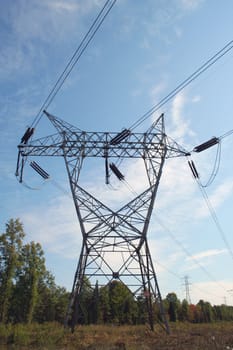 High tension power lines against blue sky