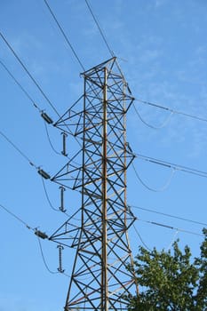 High tension power lines against blue sky