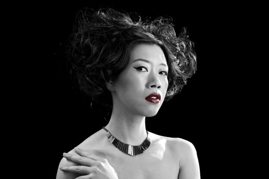 Beautiful Asian woman with red lips and bare shoulders in black and white, isolated