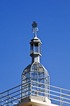 Vintage lighthouse dome with beautiful weathercock, Lisbon, Portugal
