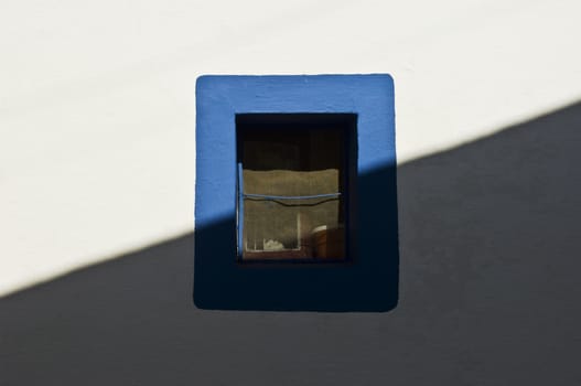Small window painted with a blue border 
