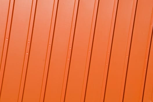 Corrugated metal panel painted in vivid orange.
