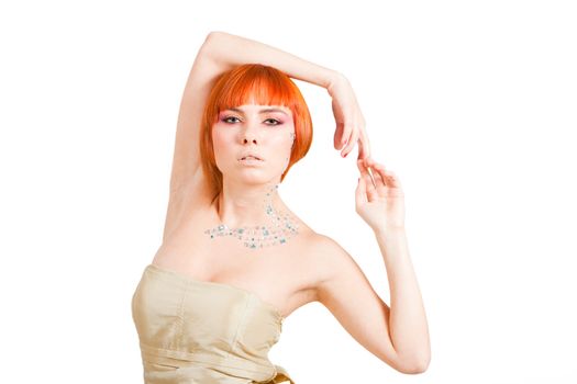 Beautiful redhead Caucasian girl with rhinestones and arms around her head, isolated