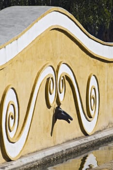 Bronze horse head decorating a stable fountain
