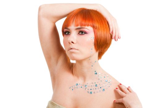 Beautiful redhead Caucasian girl with rhinestones and arm around her head and hand on shoulder, isolated