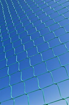 Nylon net pattern detail against a clear blue sky
