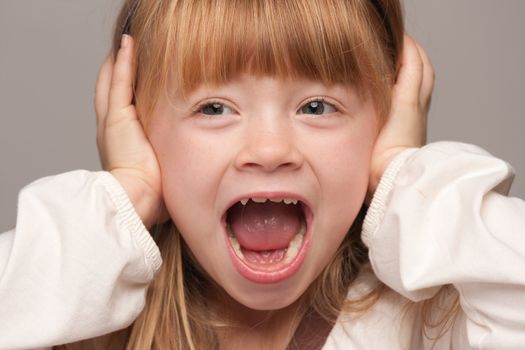 Portrait of an Adorable Red Haired Girl on a Grey Background.