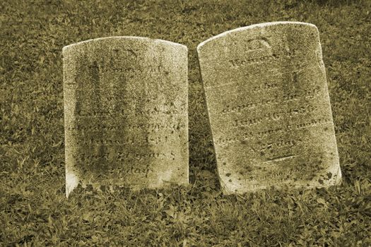 Two Old Gravestone with grass in a graveyard