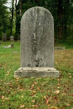 Old Gravestone with grass in a graveyard