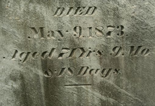 Old Gravestone with grass in a graveyard