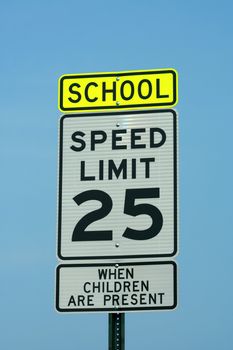 School and 25 mph sign against a blue sky