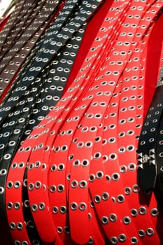 a bunch of belts at a flea market