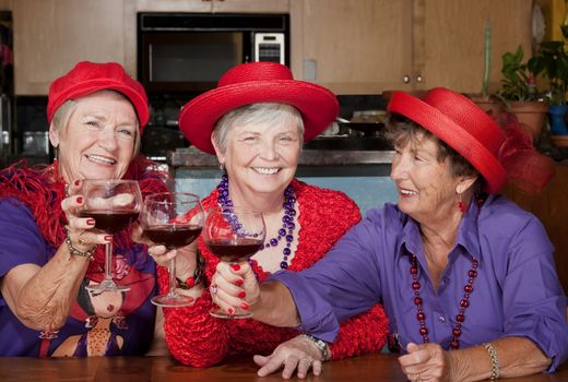 Three red hat ladies toasting with big wine glasses