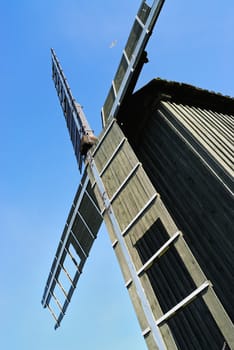 Old wooden windmill and the blue sky