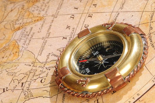 old-fashioned compass on a background an old map