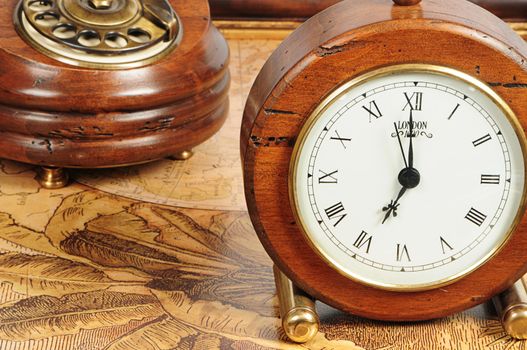 old-fashion objects as background: wooden clock and telephone