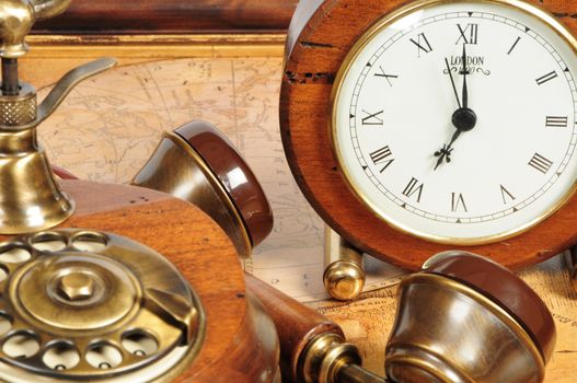 old-fashion objects as background: wooden clock and telephone