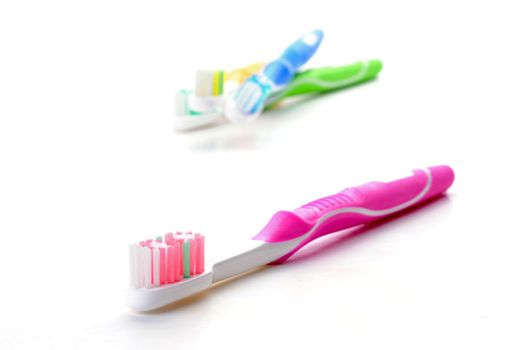 Neon pink toothbrush on a white background.