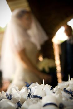 Confetti bubbles in a bowl in outside the church with the bride in the background about to enter the church