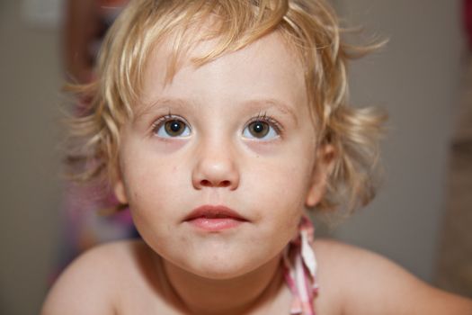 Portrait of cute little European toddler girl having fun and smiling.