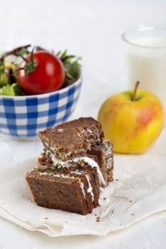 Healthy lunch for takeaway with apple, salad, and wholewheat bread