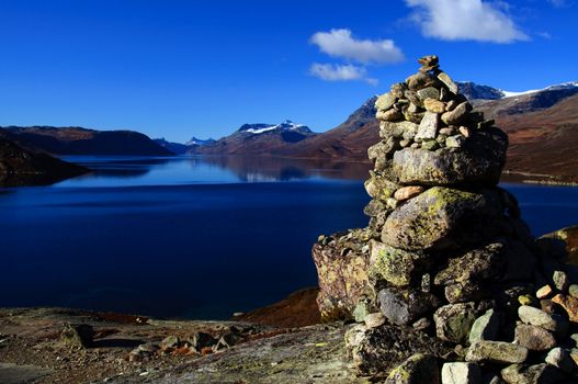 A mountain cairn overlooking a lake