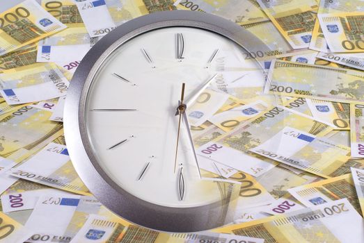 Clock and 200 euro banknotes on a white background