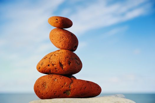 Several red-cobble-stones in tandem on the shore