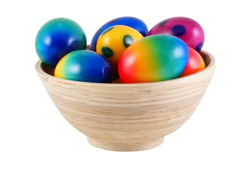 Easter eggs in wooden bowl, isolated on white.