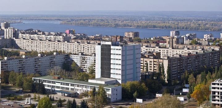 Urban landscape. Typical residential area on the riverbank. The view from the heights in the background the river Volga and Zhiguli Mountains. Russia.  