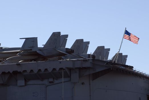 Aircraft on the back of a US aircraft carrier, flying the national flag