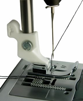 Isolated sewing machine foot closeup and needle