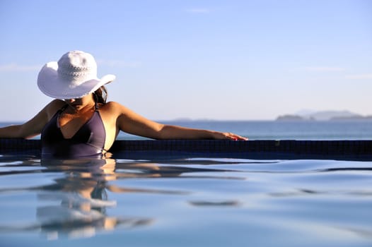 Pretty woman enjoying the swimming pool in Buzios, Brazil