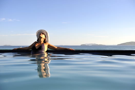Pretty woman enjoying the swimming pool in Buzios, Brazil