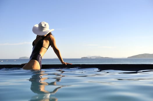 Pretty woman enjoying the swimming pool in Buzios, Brazil