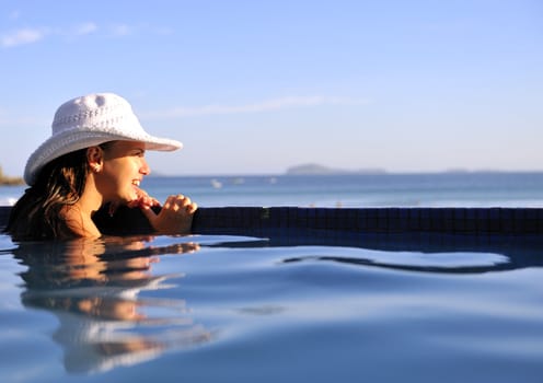 Pretty woman enjoying the swimming pool in Buzios, Brazil