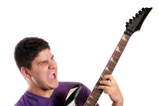 A man in his late teens rocks out while playing his electric guitar.