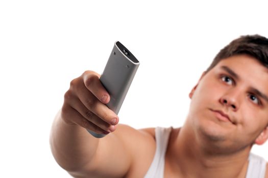 A teenager changes the channel with the remote control isolated over a white background. Shallow depth of field.