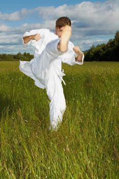 The young man polish a kick - karate