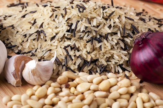 Raw ingredients: wild rice, garlic, red onion and pine nuts.