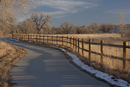 bike trail in Colorado from Windsor to Greeley along Poudre River in typical winter conditions with just traces of snow