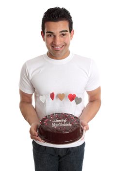 A man carries a delicious chocolate cake decorated with iced hearts in colours of red, pink, gold, and silver.  Writing on cake - Happy Birthday - but could be changed in photoshop.