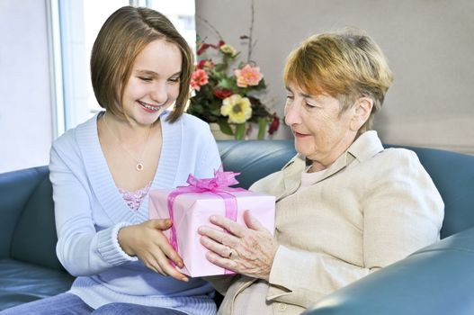 Granddaughter giving a present to her grandmother