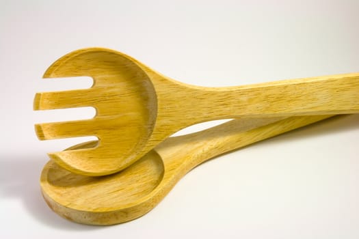 Wooden salad serving utensils on a white background