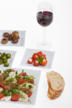 antipasti misti and bread on white plates