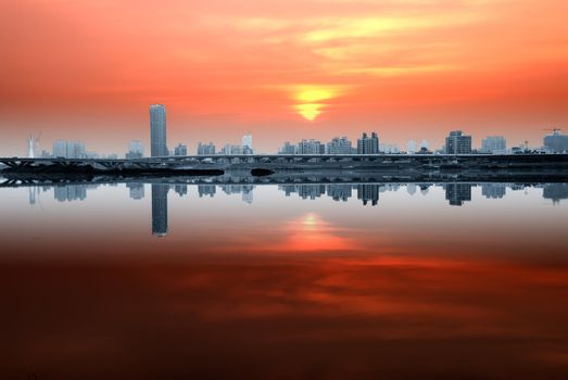 Warm orange clouds and cold blue city