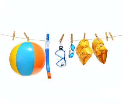 Child's pools toys with clothesline on white background