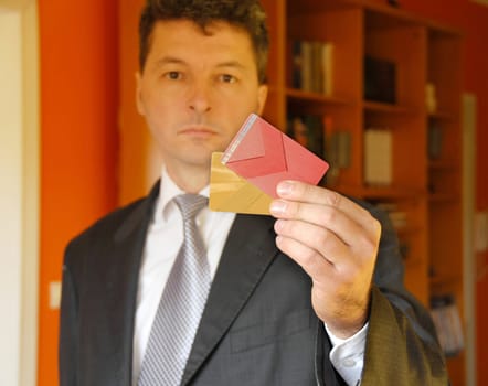 mature businessman holding plastic credit cards in hand